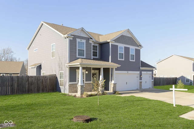 view of front of house featuring a porch, a garage, and a front lawn