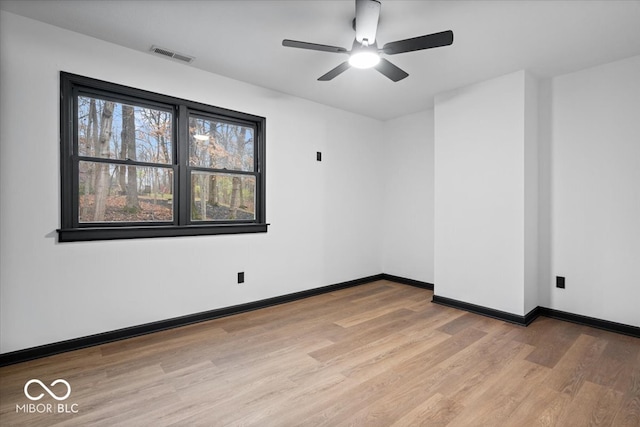 empty room with light hardwood / wood-style floors and ceiling fan