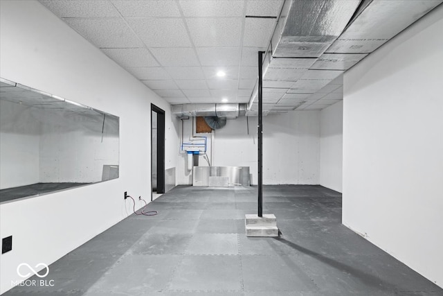 basement featuring a paneled ceiling