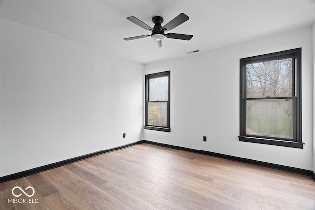 spare room featuring ceiling fan and light hardwood / wood-style flooring