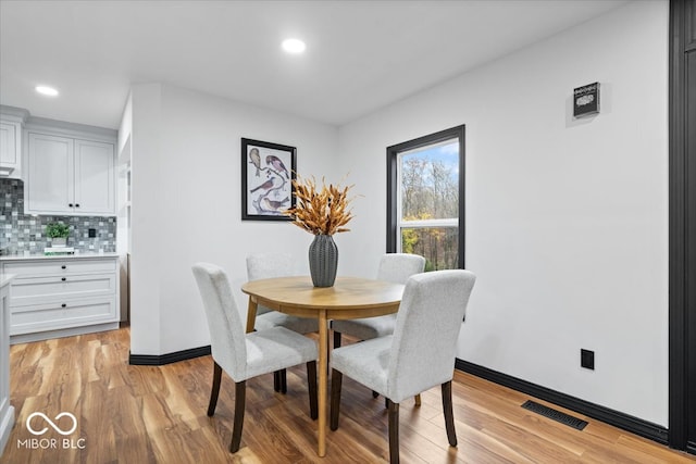 dining space with light hardwood / wood-style floors