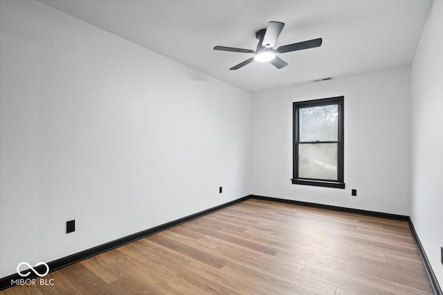 spare room with light wood-type flooring and ceiling fan