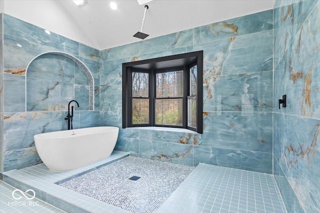 bathroom featuring separate shower and tub, lofted ceiling, and tile walls