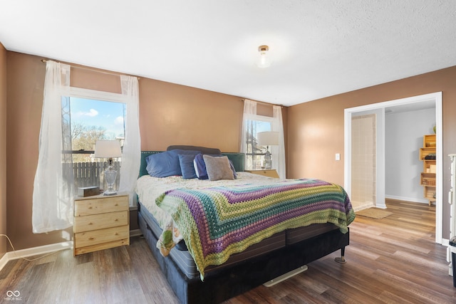 bedroom featuring wood-type flooring and a textured ceiling