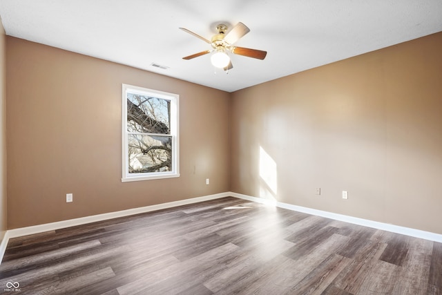 spare room featuring ceiling fan and dark hardwood / wood-style flooring