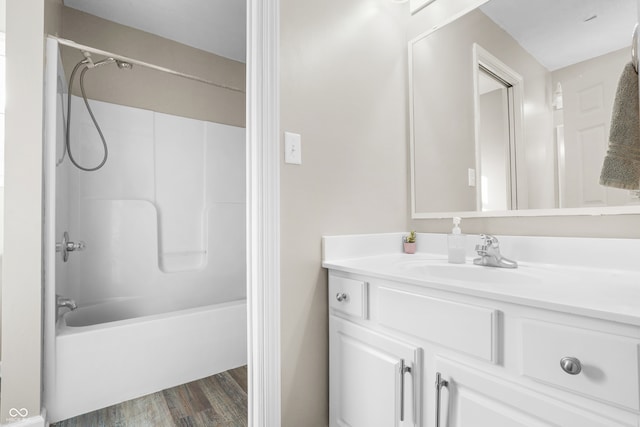 bathroom featuring hardwood / wood-style floors, vanity, and tub / shower combination