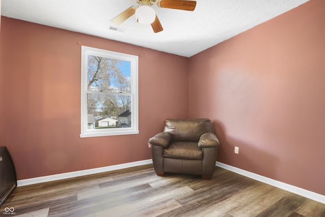 sitting room featuring ceiling fan and hardwood / wood-style floors