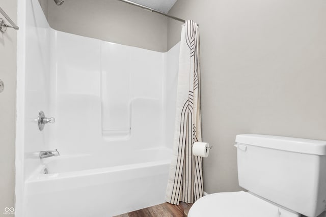 bathroom with toilet, shower / tub combo, and hardwood / wood-style flooring