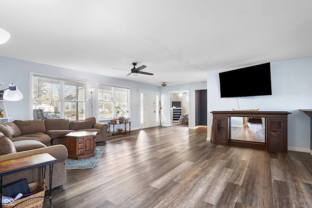 living room with ceiling fan and dark hardwood / wood-style floors