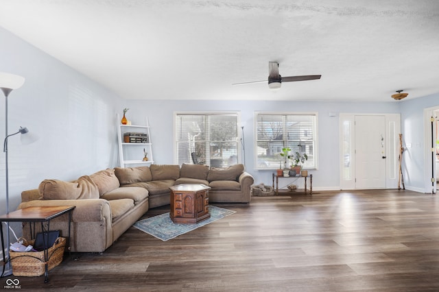 living room featuring a textured ceiling, dark hardwood / wood-style flooring, and ceiling fan