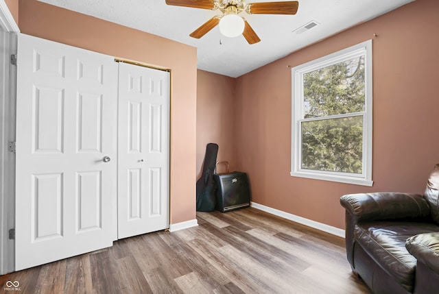 sitting room featuring light hardwood / wood-style floors and ceiling fan