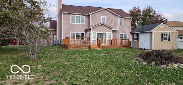 back of property with a yard, a storage unit, and a wooden deck