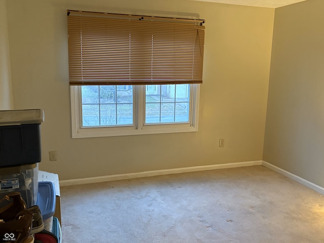 unfurnished living room with light colored carpet