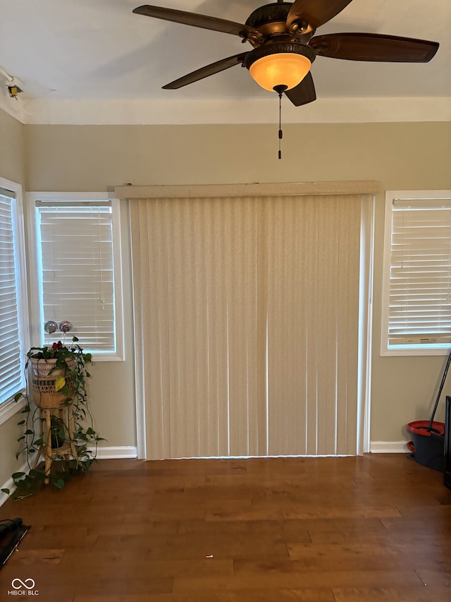 spare room with dark hardwood / wood-style floors and ceiling fan