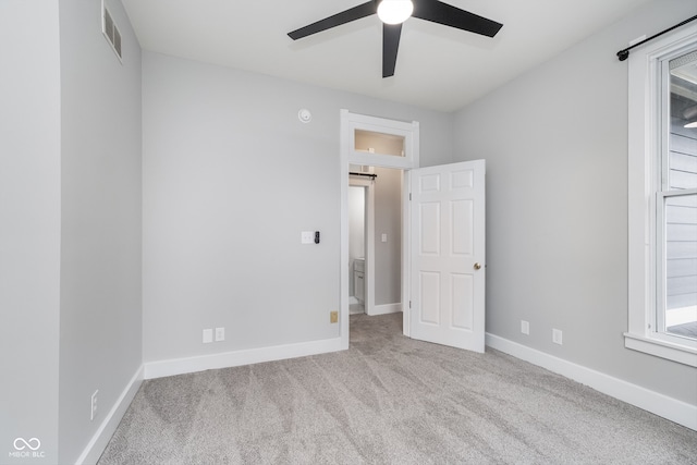 unfurnished bedroom with ceiling fan and light carpet