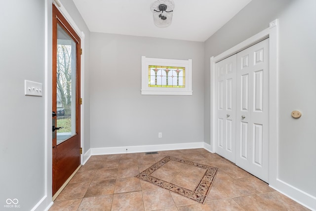 tiled foyer entrance with a wealth of natural light