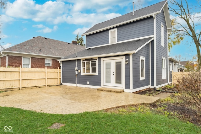 back of property featuring a yard and a patio