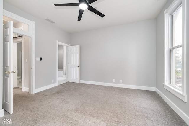 unfurnished bedroom featuring ceiling fan and light carpet