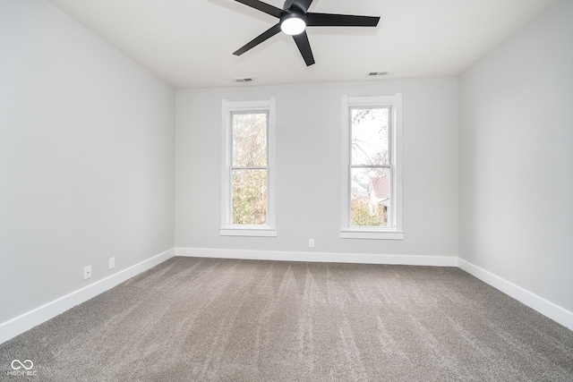 carpeted spare room with ceiling fan