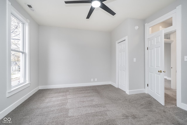 spare room featuring ceiling fan and carpet