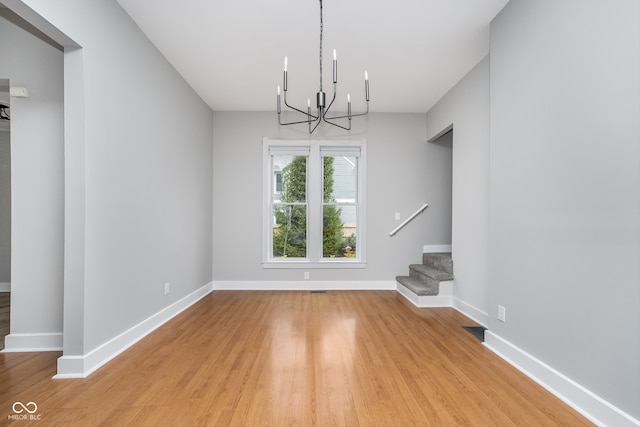 interior space with light wood-type flooring and a chandelier