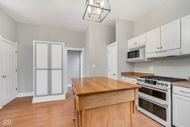 kitchen with white appliances, light hardwood / wood-style flooring, decorative light fixtures, a kitchen island, and white cabinetry