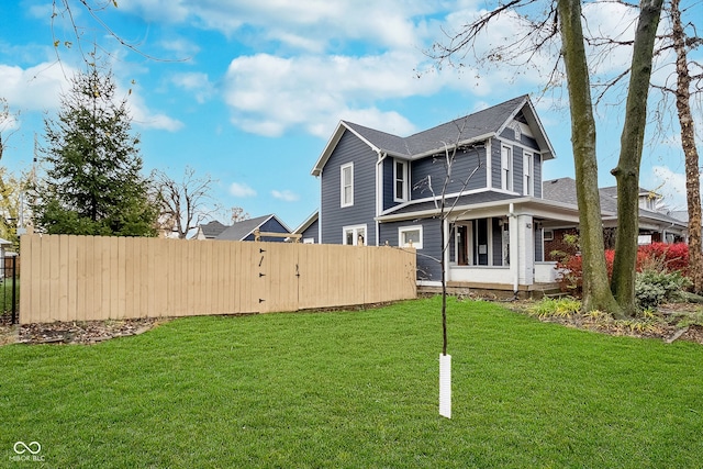 rear view of house featuring a yard