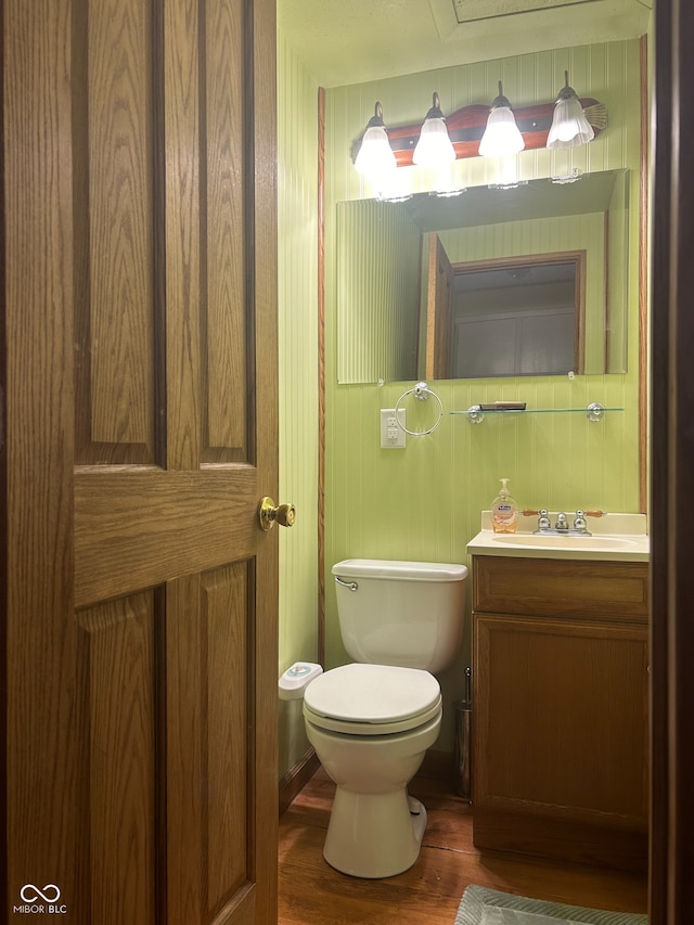 bathroom featuring hardwood / wood-style floors, vanity, and toilet