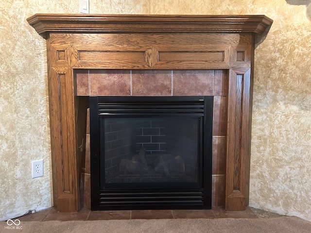 room details featuring a tile fireplace