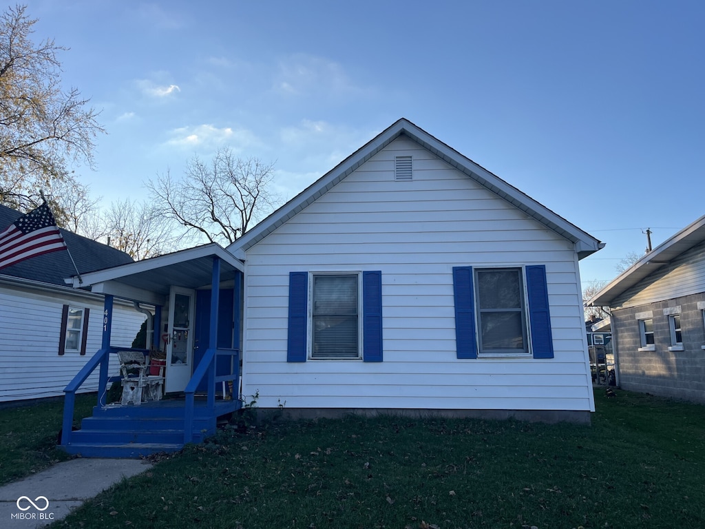 bungalow-style house with a porch and a front yard