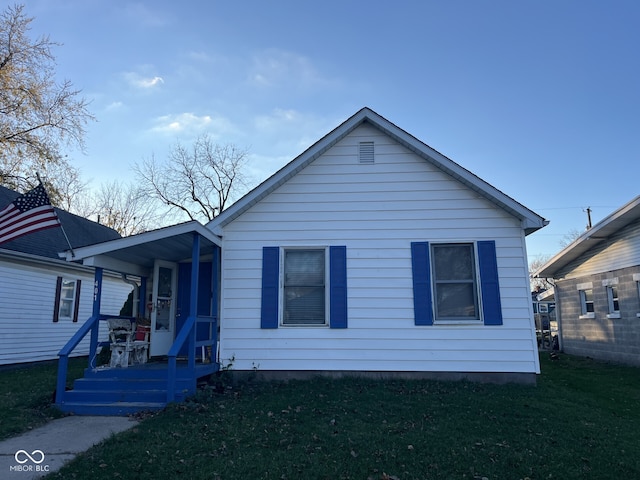 bungalow-style house with a porch and a front yard