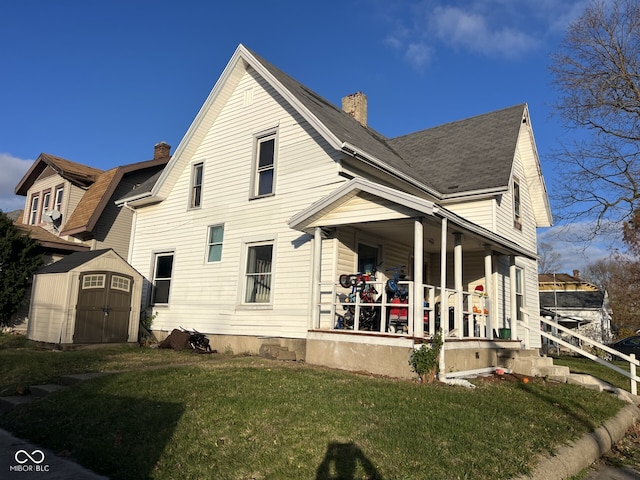 exterior space with covered porch, a front lawn, and a storage shed