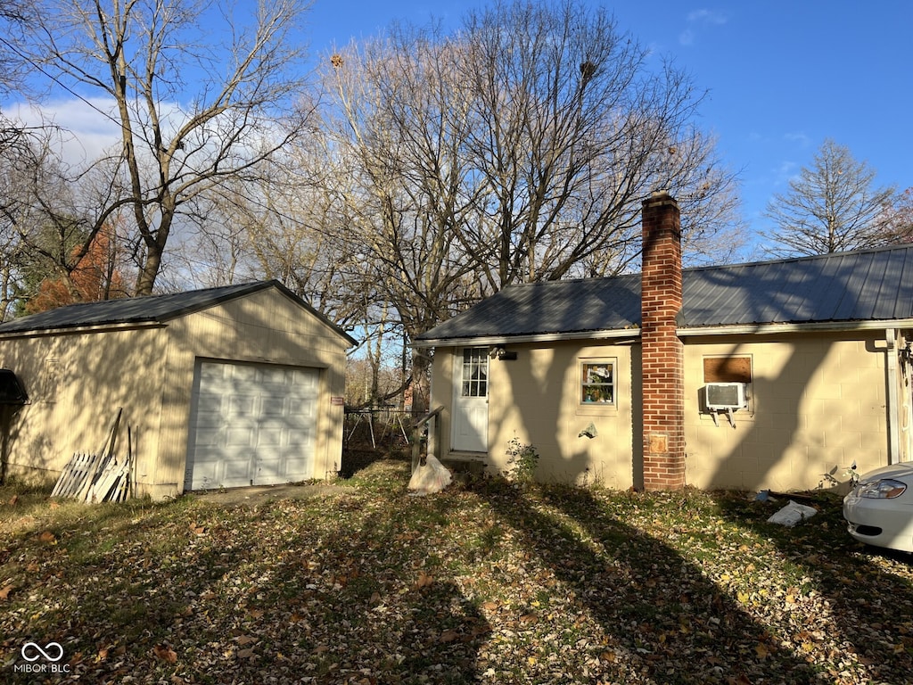 exterior space featuring an outbuilding, cooling unit, and a garage