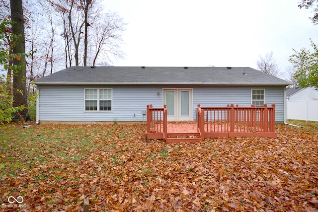 back of house with a deck