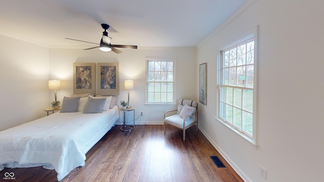 bedroom featuring ceiling fan, dark hardwood / wood-style floors, and ornamental molding