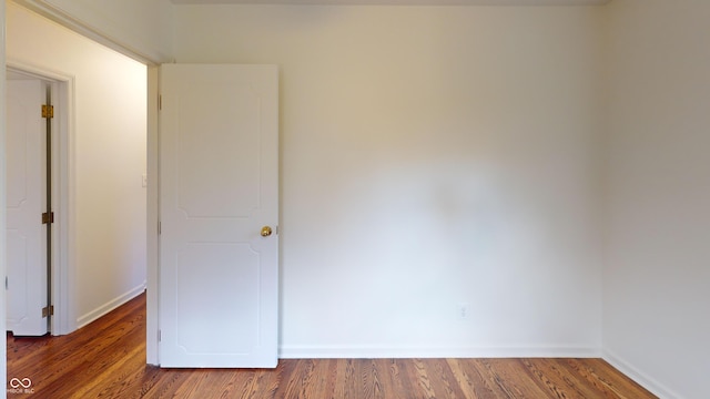 empty room featuring dark hardwood / wood-style flooring