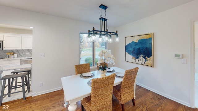 dining space with wood-type flooring