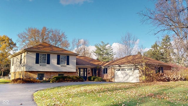 view of front of home with a garage and a front yard