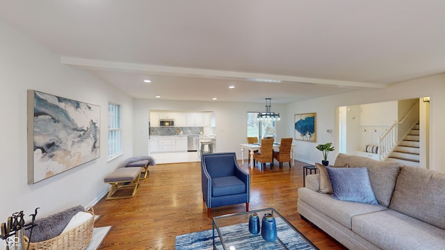 living room with beamed ceiling and light wood-type flooring