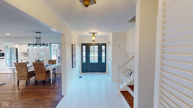 entryway with a notable chandelier and light wood-type flooring