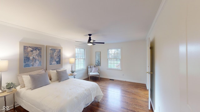 bedroom featuring ornamental molding, ceiling fan, and dark wood-type flooring