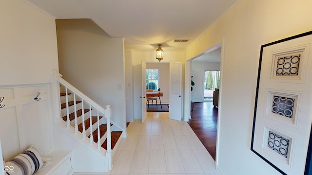 entrance foyer featuring light hardwood / wood-style floors and crown molding