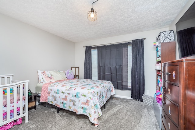 bedroom with carpet floors and a textured ceiling