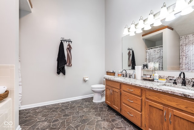 bathroom with a shower with curtain, vanity, toilet, and a textured ceiling