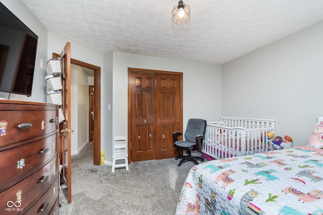 bedroom with light carpet, a closet, and a textured ceiling