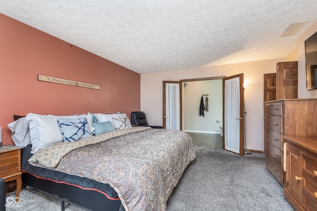 bedroom featuring carpet flooring and a textured ceiling