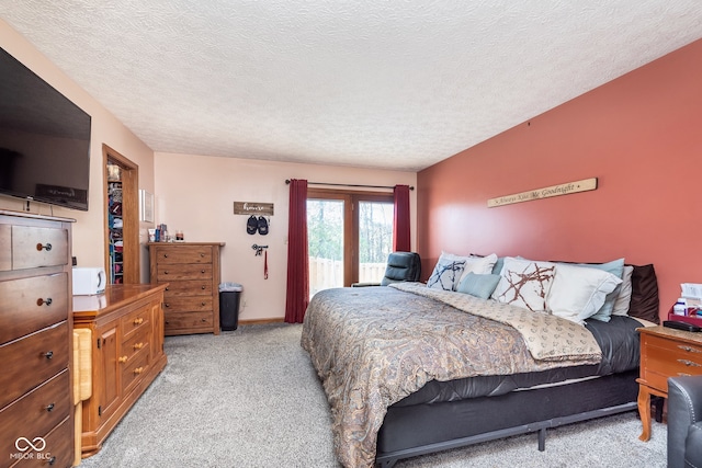 bedroom featuring a textured ceiling and light colored carpet