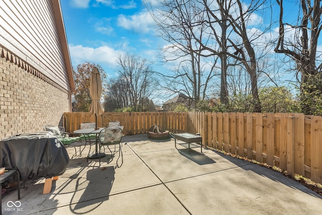 view of patio / terrace with an outdoor fire pit and grilling area