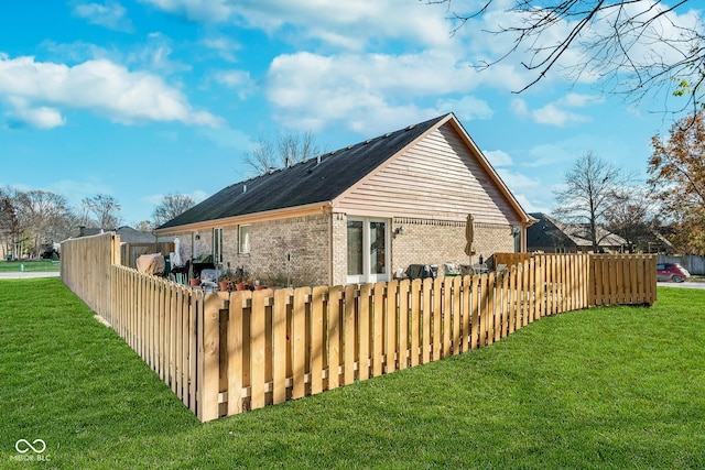 view of home's exterior with a lawn