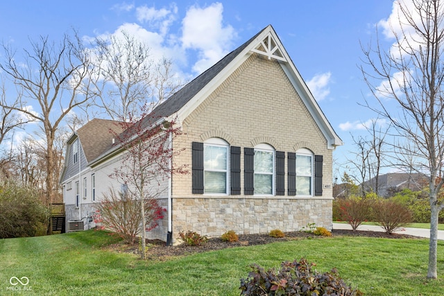 view of home's exterior featuring a lawn and central air condition unit